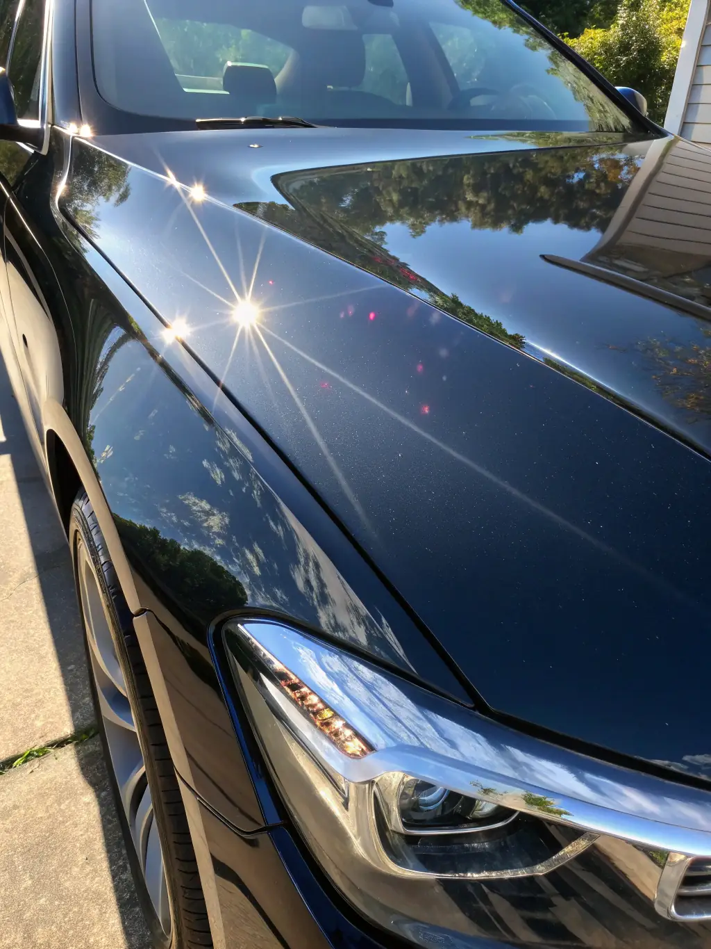 A close-up shot of a car panel with water beading perfectly on the ceramic coating, showcasing its hydrophobic properties and protective layer against water damage.