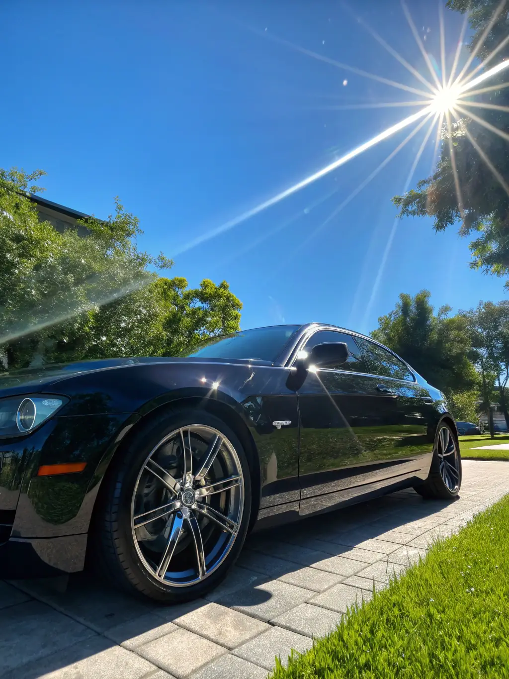 A car parked under direct sunlight, highlighting the ceramic coating's ability to protect the paint from harmful UV rays and prevent fading or discoloration.