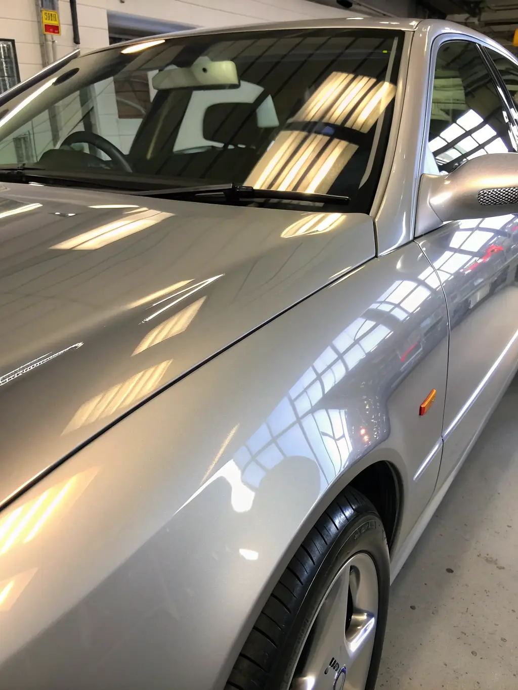 A car with a glossy, mirror-like finish after ceramic coating application, emphasizing the enhanced aesthetic appeal and showroom shine.