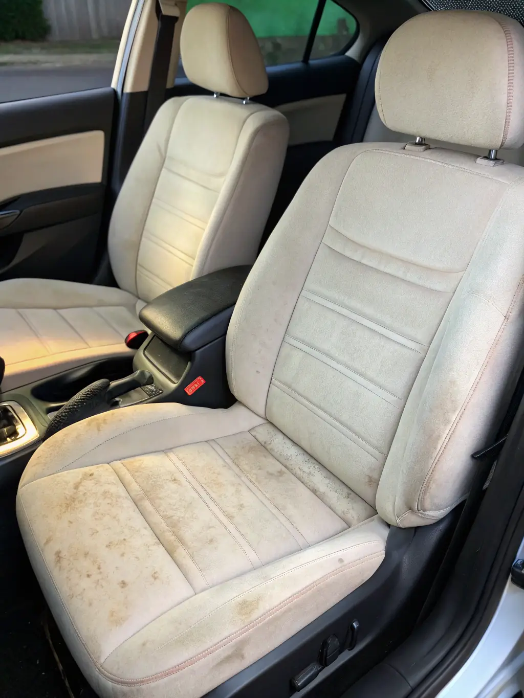 A before-and-after shot showcasing a car's dashboard and console, with the 'before' side showing dirt and grime, and the 'after' side showing a clean, polished surface, representing enhanced vehicle value.